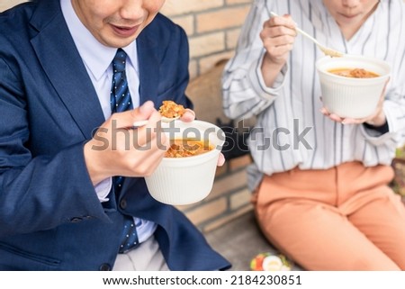 Male and female Asian office workers who eat takeout curry