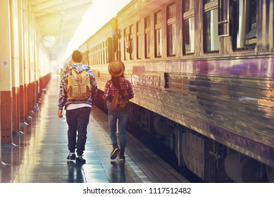 Male and female backpackers travel by train on summer vacations. - Powered by Shutterstock