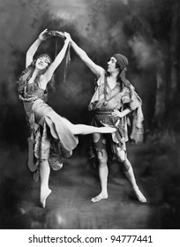 Male and female ballet dancers performing in costume
