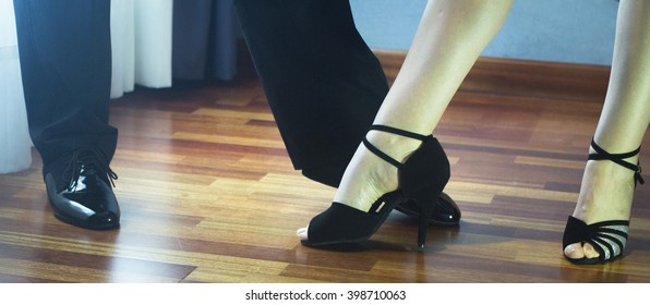 Male And Female Ballroom, Standard, Sport Dance, Latin And Salsa Couple Dancers Feet And Shoes In Dance Academy School Rehearsal Room Dancing Salsa.