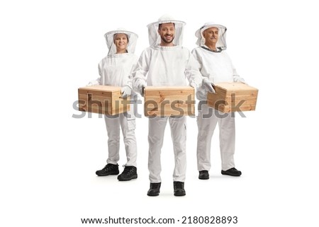 Male and female bee keepers in uniforms holding wooden boxes isolated on white backgroun