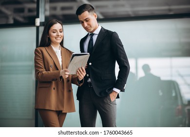 Male And Female Business People Working On Tablet In Office
