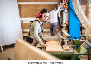 male and female carpenter at work, man and woman are crafting with wood in a workshop, two craftsmen or handymen working with carpenter tools or electric machines - Powered by Shutterstock