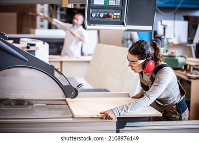 male and female carpenter at work, man and woman are crafting with wood in a workshop, two craftsmen or handymen working with carpenter tools or electric machines - Shutterstock ID 2108976149