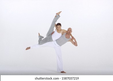 Male and female dancers in harmony, legs raised - Shutterstock ID 1587037219