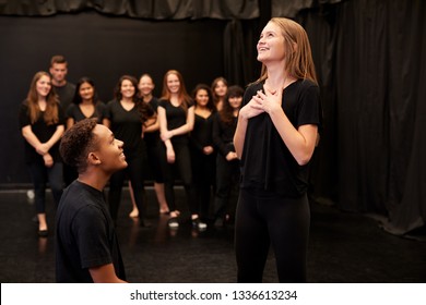 Male And Female Drama Students At Performing Arts School In Studio Improvisation Class