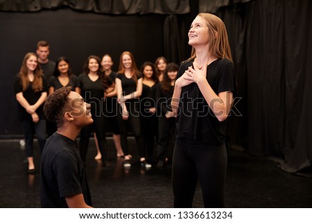 Male And Female Drama Students At Performing Arts School In Studio Improvisation Class