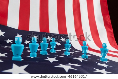Male and Female figurines on USA flag. Voting, elections, equality, patriotism, independence concept