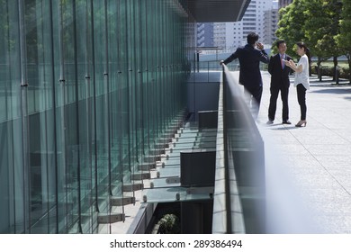 Male And Female Friends Talking Outside Building