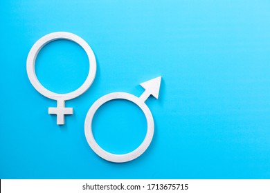 Male And Female Gender Signs On Blue Background