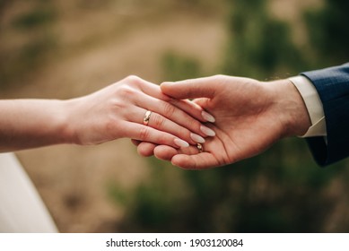 Male and female hand on a green background 