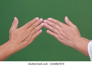 Male and female hands greeting one another on Ramadan Mubarak Holiday H 1443