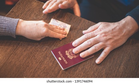 Male And Female Hands On Table Exchange Italian Passport And Money - Concept Of Illegal Immigration, Sale Of Fake Passports, Sham (fake) Marriage 