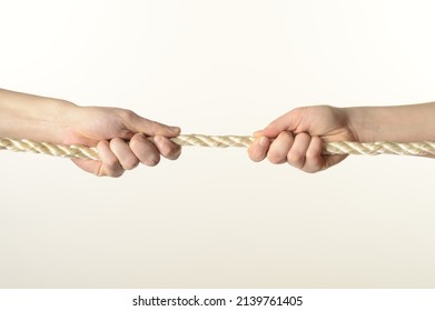
male and female hands pull the rope on a white background close-up - Shutterstock ID 2139761405