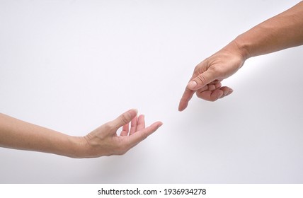 Male and female hands reaching out to each other, creation of adam sign. Isolated on white background. Concept of connection and human relations. - Powered by Shutterstock