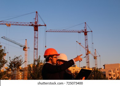 male and female in the helmets on the background of the building - Shutterstock ID 725073400