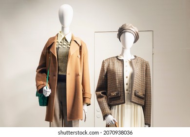 Male and female mannequins in a shop window. Stylish new collection for the autumn-winter season. 