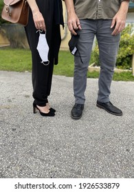 Male And Female Married Couple Outside Holding Their Face Masks After Exiting A Church Service On Sunday Morning Due To Covid-19 Virus.