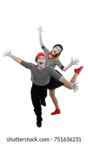 Male And Female Mimes Dancing With Wide Open Arms. Spectacular Pantomime Show Performed By Mime Artists, Dressed In Striped Shirts, Bow Ties And Berets.