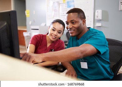 Male And Female Nurse Working At Nurses Station