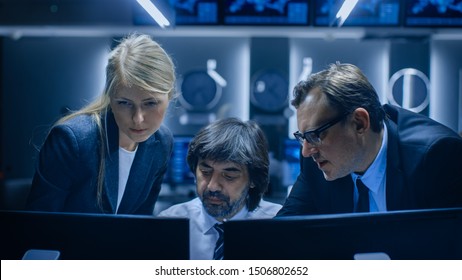 Male And Female Operators Working On Computers In System Control Room. Secret Government Agency Analysts Doing Research, Conducting Cyber Security Investigation.