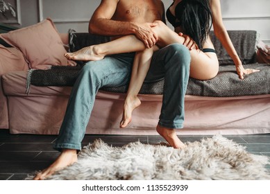 Male And Female Person Hugs On Couch, Erotica