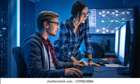 Male And Female Programmers Talking, Solving Problem, Using Computers, Doing High Five After Success. Software Development / Code Writing / Website Design / Database Architecture. Technical Department