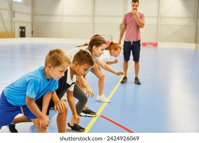 Male and female schoolkids preparing for spring run during gym class - Powered by Shutterstock