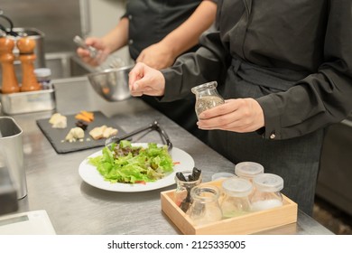 Male And Female Staff Serving Food At The Restaurant