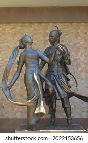 male and female statues dancing