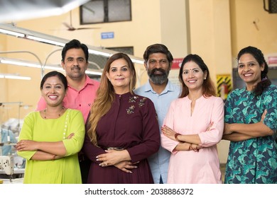 Male And Female Textile Workers Standing Together In Solidarity At Factory