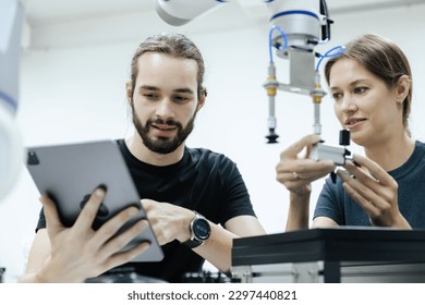 Male and female using tablet staff engineer with robot for education at class room. Education for future robotics learning innovation. Workshop maintenance technical. - Powered by Shutterstock