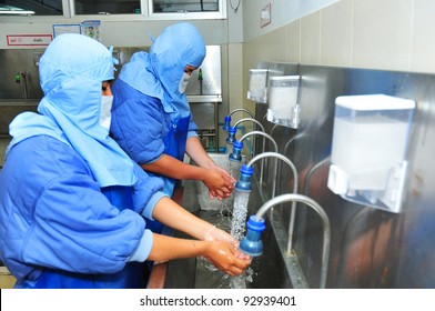 Male And Female Washing Hands In Factory(sanitation)