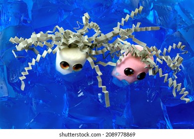 Male And Female Or White And Pink Marshmallows With Toy Doll Eyes And Gray Crinkled Shredded Paper Hair In A Sea Of Blue Blueberry Gelatin