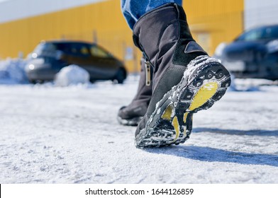 Male Or Female Winter Boots Walking On Snowy Sleet Road	