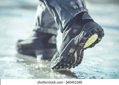 Male Or Female Winter Boots Walking On Snowy Sleet Road. Toned Cold Image