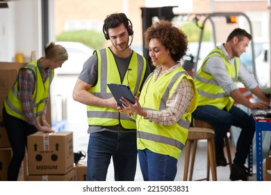 Male And Female Workers Wearing Headsets In Logistics Distribution Warehouse Using Digital Tablet - Powered by Shutterstock