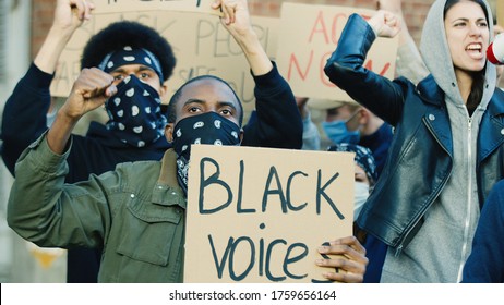 Male And Female Young Multiethnic Students Protesting And Screaming Slogans For Black People Dignity And Equality. Manifestation For Rights Of African Americans. Demonstration For Democracy At Street.