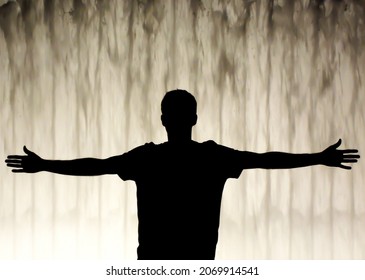 Male figure extending his arms by the fountain - Powered by Shutterstock