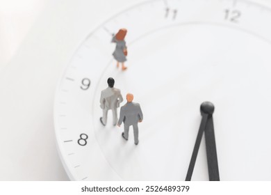 Male figurines standing on the white clock. 
Image of working hours, career, employment, deadline, and appointment. - Powered by Shutterstock