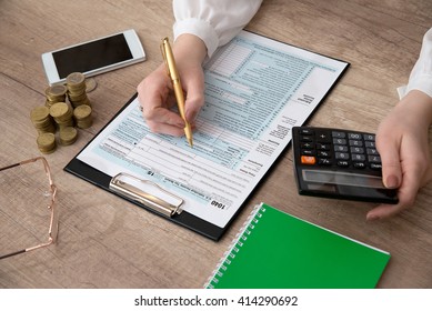 Male filling US 1040 Tax Form