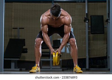 Male Fitness Athlete Doing Heavy Weight Exercise For Back