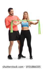 Male fitness trainer showing an exercise to a woman with an elastic band isolated on white background