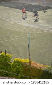 Male Football Player Training At A Sports Field. Soccer Player Avoids Incoming Slide Tackle During A Soccer Match. 