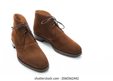 Male Footwear Ideas. Closeup of Pair of Mens Brown Suede Chukka Boots Against White Background. Horizontal Image Composition - Powered by Shutterstock