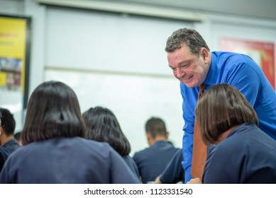 Male Foreign English Teacher Is Teaching High School Students In Classroom,  Thailand, Southeast Asian.