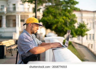 male freelancer  doing work using the laptop in the street