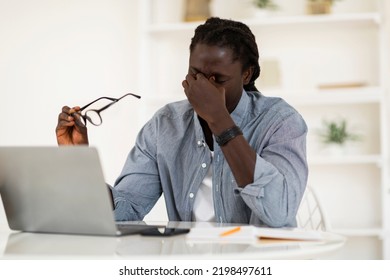 Male Freelancer Suffering Eyes Strain, Taking Off Glasses And Massaging Nose Bridge, Young African American Man Tired After Working On Laptop Computer At Home Office, Copy Space - Shutterstock ID 2198497611