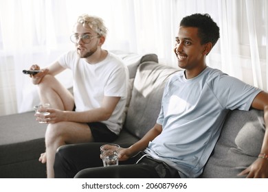 Male Friends Watching Tv Together In A Bright Room