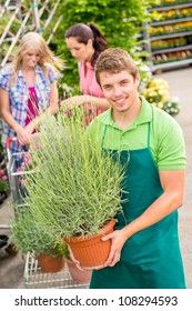 Male Garden Center Worker Hold Potted Plant